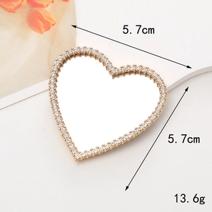 Detailed view of heart-shaped rhinestone vanity mirror accessory for phone case DIY