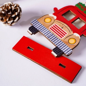 Detailed view of red wooden Christmas truck ornament with festive gift box details