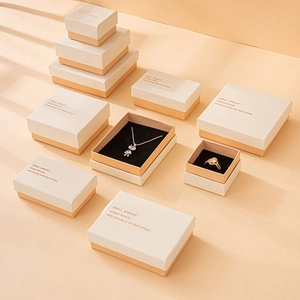 Elegant beige and white jewelry gift boxes in various sizes with premium gold foil logo