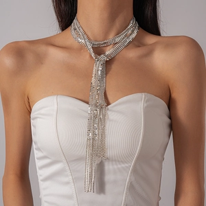 Macro detail of silver mesh tassel necklace with sparkling rhinestones and metal fringe