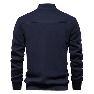Rear view of dark blue waffle knit men's jacket with ribbed cuffs and stand collar