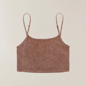 Macro detail of brown washed fabric with distressed texture on a cropped sports tank top