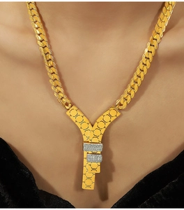 Detail of 18k gold plated Cuban chain with Y-letter pendant and honeycomb pave zircon
