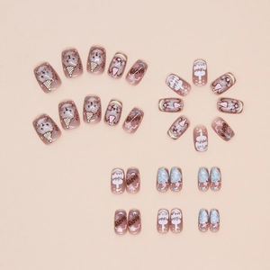 Detailed close-up of cute puppy press-on nails with cat-eye glitter and party cake patterns