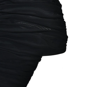 Close-up of black mesh fabric showing elegant ruched texture and sheer material details