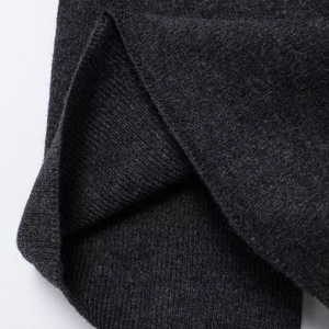 Close-up of high-quality dark grey diamond knit fabric with detailed texture for women's set