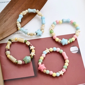 Handmade ceramic beaded bracelets in pastel macaron colors and star-shaped charms