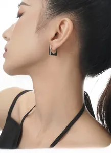 Minimalist S925 sterling silver square hoop earrings worn by a model in a high-fashion pose