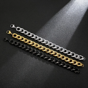 Three Cuban link chains in silver, gold, and black colors on a dark background
