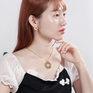 Gold Mom jewelry set with heart necklace and round earrings featuring sparkling crystals