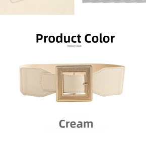 Detail view of a cream-colored elastic wide belt featuring a large gold square metal buckle
