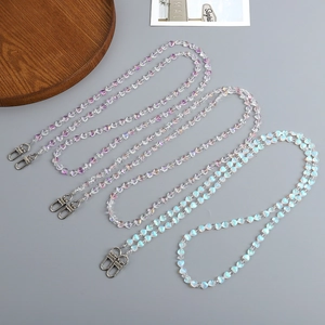 Close-up of three iridescent beaded straps with metal lobster clasps on a tray