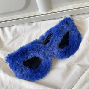 Close-up of vibrant royal blue faux fur sunglasses on a soft white fabric background