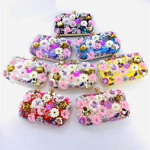 Detailed top view of handmade evening bags with 3D floral beading and gold clasps