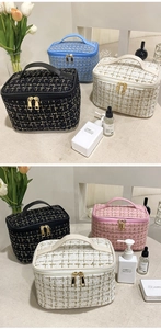 Close-up of elegant tweed makeup bags with gold zippers in various colors and styles