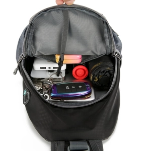 Internal compartments of nylon crossbody bag showing storage for umbrella and power bank