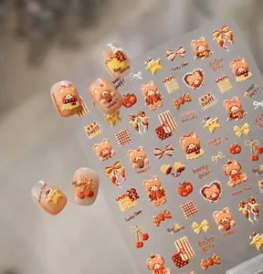 Detail of honey caramel bear nail stickers with red cherries and yellow stars