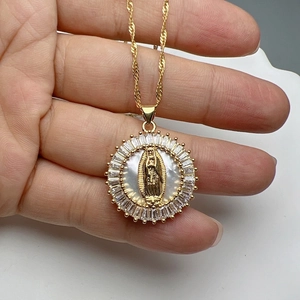 Close-up of Virgin Mary shell pendant with zircon border and golden rope chain