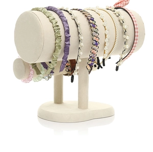 Detail of double-layer beige velvet T-bar stand displaying headbands and hair accessories