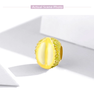 Close-up of a realistic enamel durian fruit bead charm for DIY bracelet jewelry