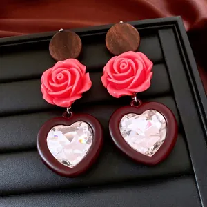 Vintage long drop heart earrings with wooden beads and pink resin roses on black leather