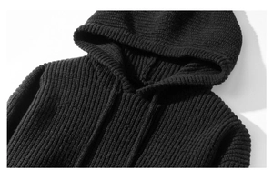 Detailed close-up of the black ribbed knit hood and neckline texture on the sweater