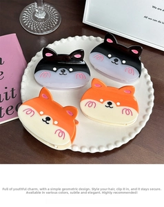 Set of four cute Corgi and cat acetate hair claws displayed on a white decorative plate