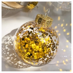Detail of transparent Christmas ball filled with sparkling gold sequins and metal cap