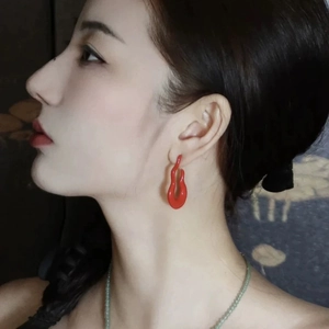 Minimalist red hollow gourd-shaped earring shown on model with vintage artistic lines
