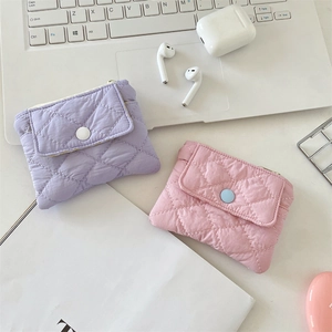 Detailed view of quilted small wallets in lavender and pink with snap button closure