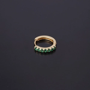 Detailed macro view of a gold-plated earring featuring seven vibrant green round zircons