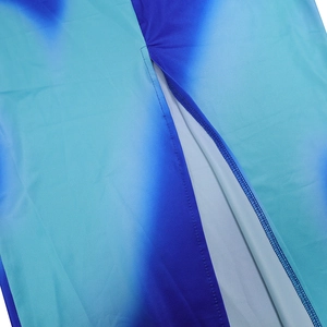 Macro shot of blue gradient stretch fabric with neat overlock stitching on the side slit