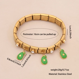 Detail of gold stretch bracelet with avocado pendants and inlaid crystals on beige background