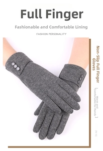 Detail of grey winter knit gloves with decorative buttons and warm lining for women