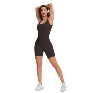 Close-up of ribbed seamless deep brown yoga jumpsuit featuring cross-back and biker shorts