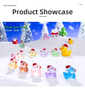 Miniature resin Christmas ducks in colorful hats on a snowy holiday scene background