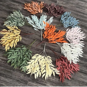 Detail view of artificial willow leaves in multiple colors arranged on dark background