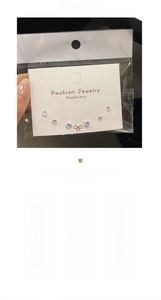 Detail view of six-piece cubic zirconia stud set with jewelry care instructions