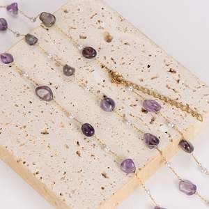 Chic gold chain necklace with irregular purple crystals and white pearls on stone