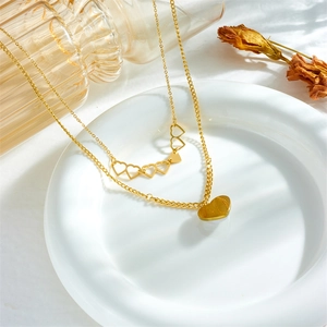 Double-layer gold heart necklace with openwork hearts and a pearl solid pendant