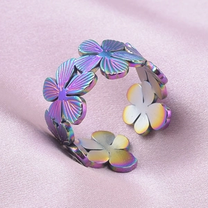 Macro shot of rainbow-plated flower ring on silk background featuring adjustable band