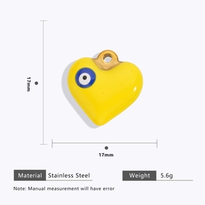 Detail view of a 17mm yellow stainless steel heart evil eye charm with size measurements