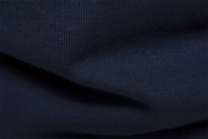 Detailed close-up showing the dense knitting texture of high-quality navy blue wool fabric