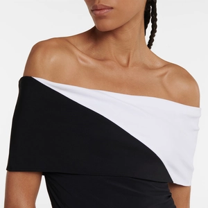 Detailed view of the off-the-shoulder neckline on a black and white contrast swimsuit
