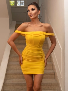 Detail of yellow off-the-shoulder mini dress with elegant ruched texture and slim fit