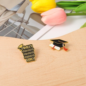 Graduation enamel pin set featuring classic mortarboard cap and Finally Graduated Done text