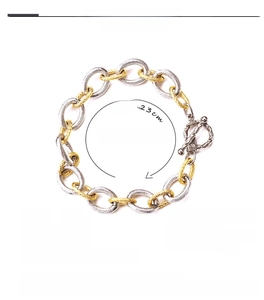 Detail view of 12mm wide titanium steel chain bracelet with 18K gold and silver links
