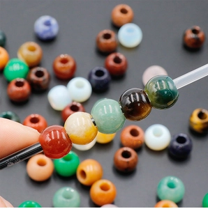 Close-up of multicolored 12mm natural stone beads with holes for DIY jewelry making