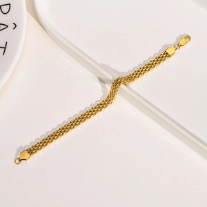 Macro view of 18K gold mesh woven chain bracelet with adjustable lobster clasp