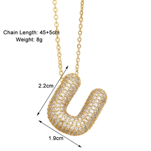 Detail of gold letter U pendant with cubic zirconia, size 2.2x1.9cm, chain 45+5cm